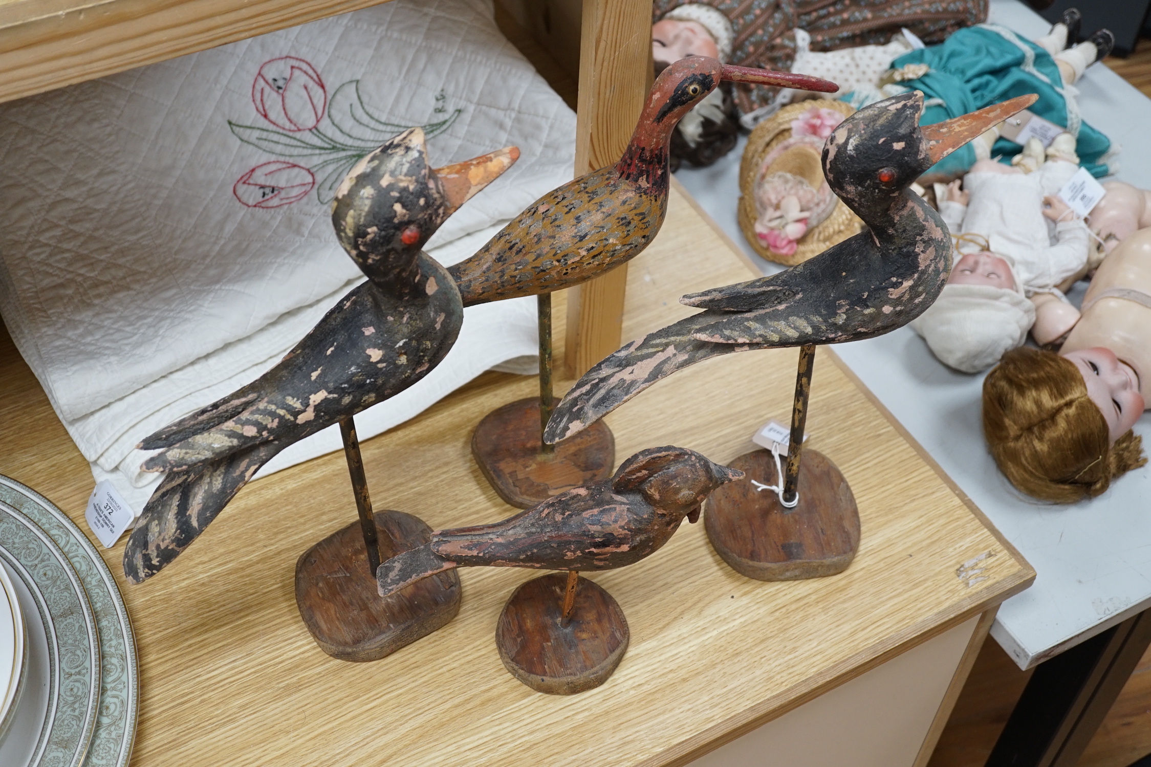 Four various wooden folk art wild birds. Tallest 43cm